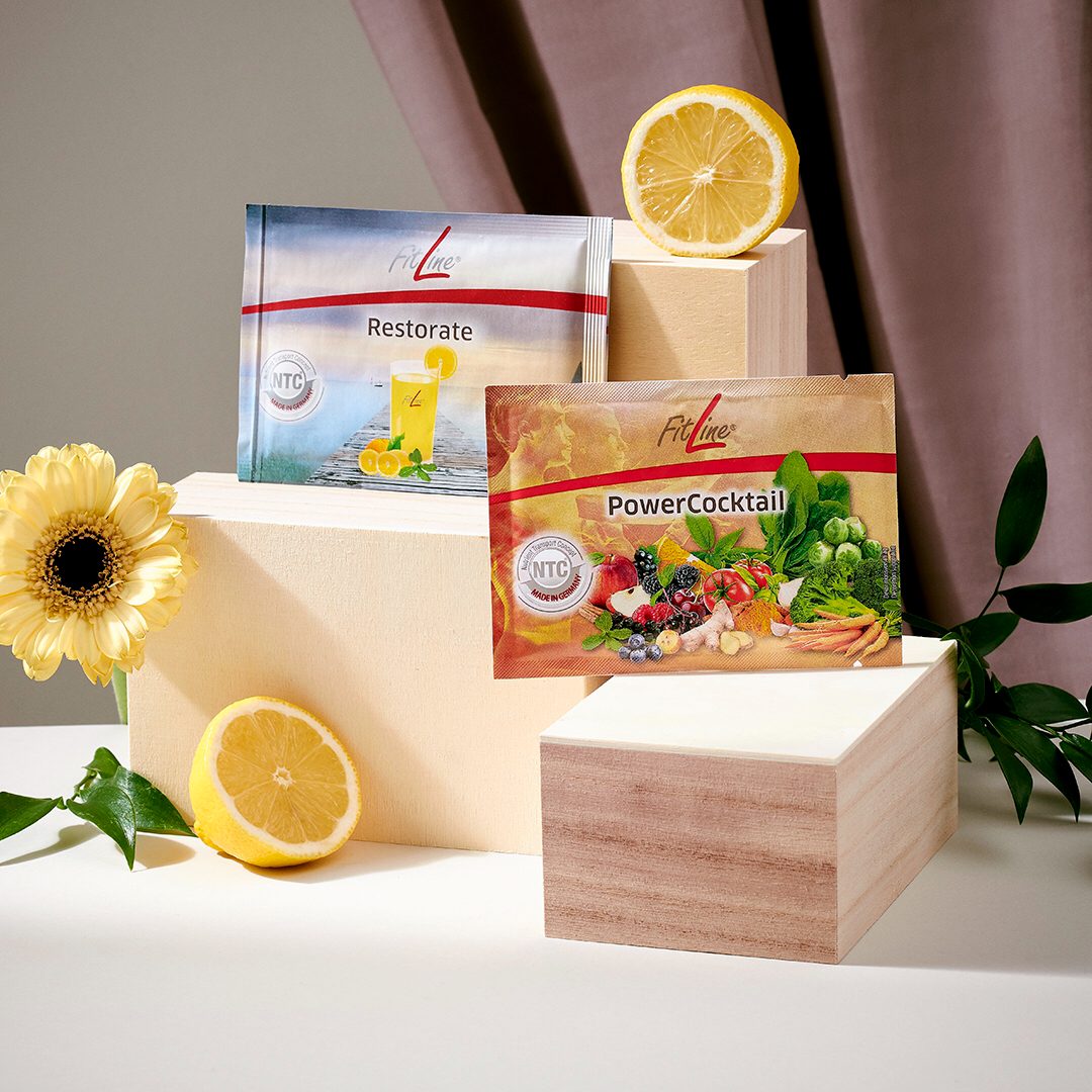 PowerCocktail-Dose und Restorate-Dose nebeneinander auf einem Holztisch, warmes natürliches Licht, ruhige Komposition als Paar